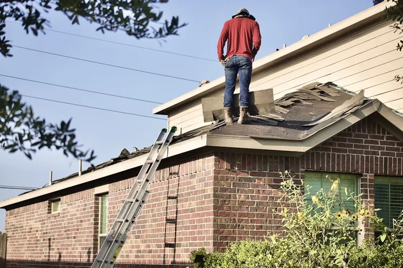 Professional roofer working on a residential roof in Hallandale